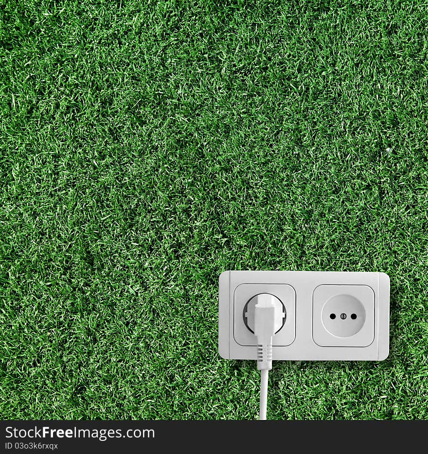 Plug and socket on the grass. Plug and socket on the grass