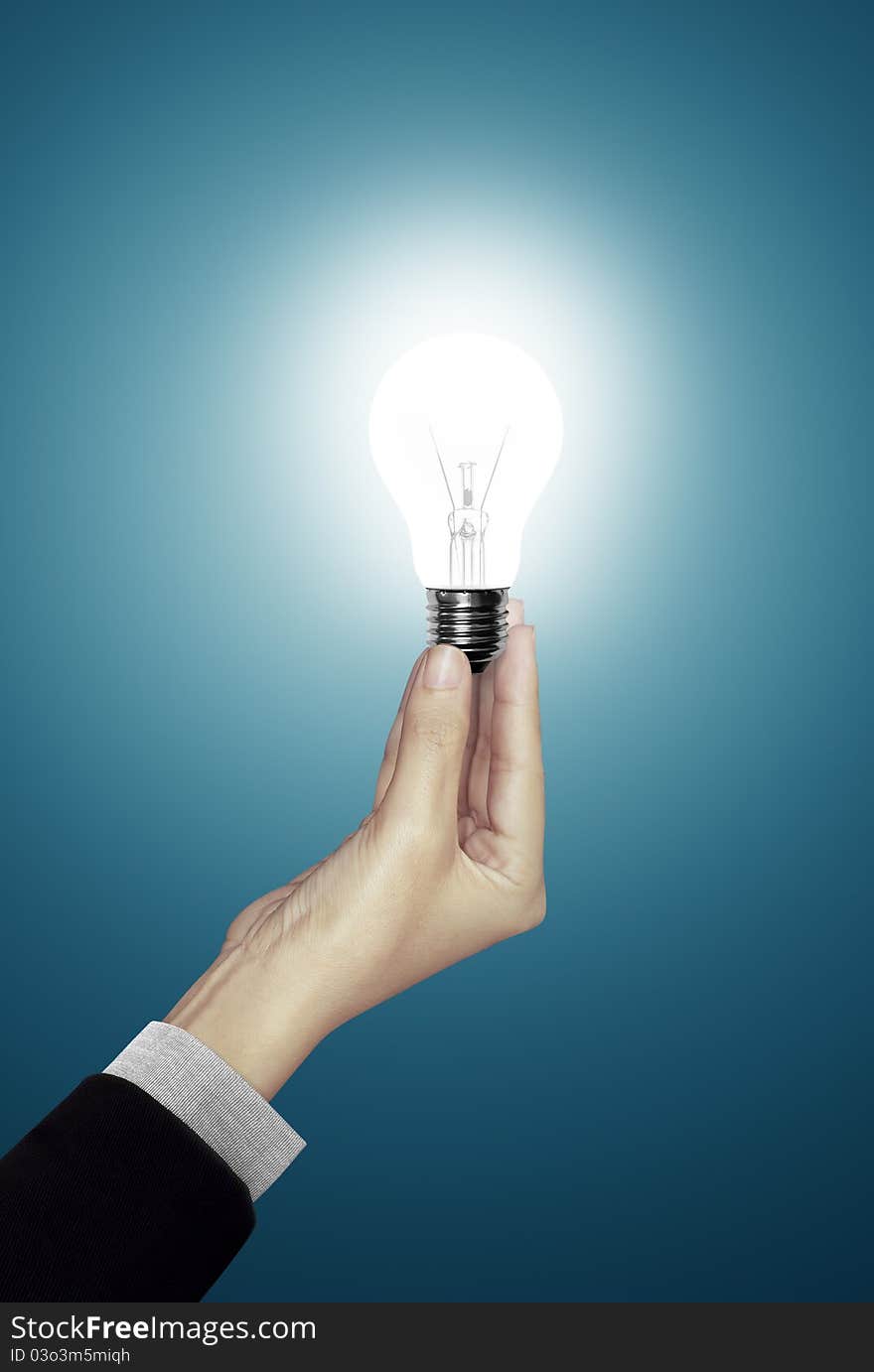 Blue background of Bulb light in woman hand