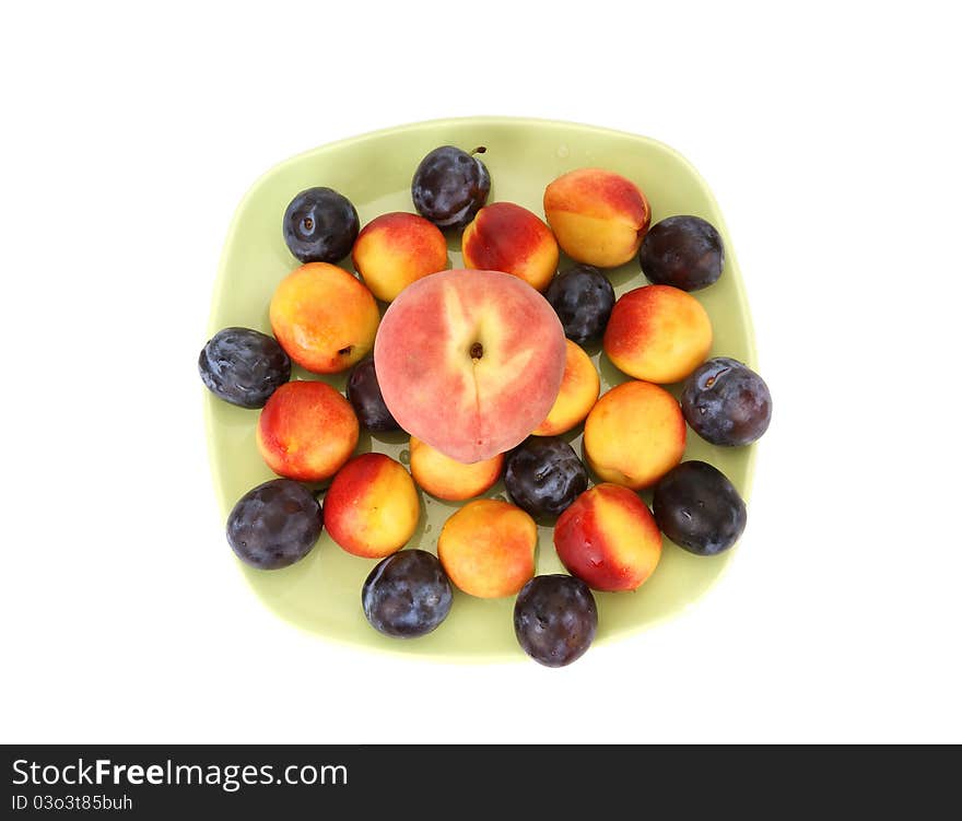 Still life with natural ripe plums and peaches on a white background