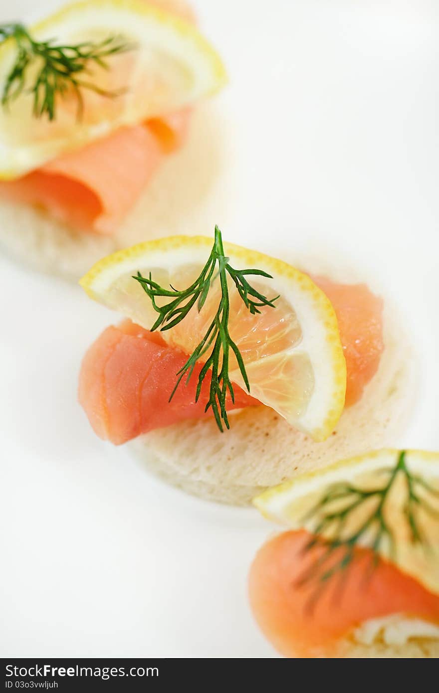 Extreme close-up of smoked salmon served with lemon, cheese and dill. Extreme close-up of smoked salmon served with lemon, cheese and dill