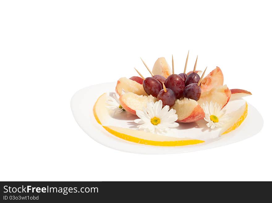 The dessert from fruits, decorated with flowers