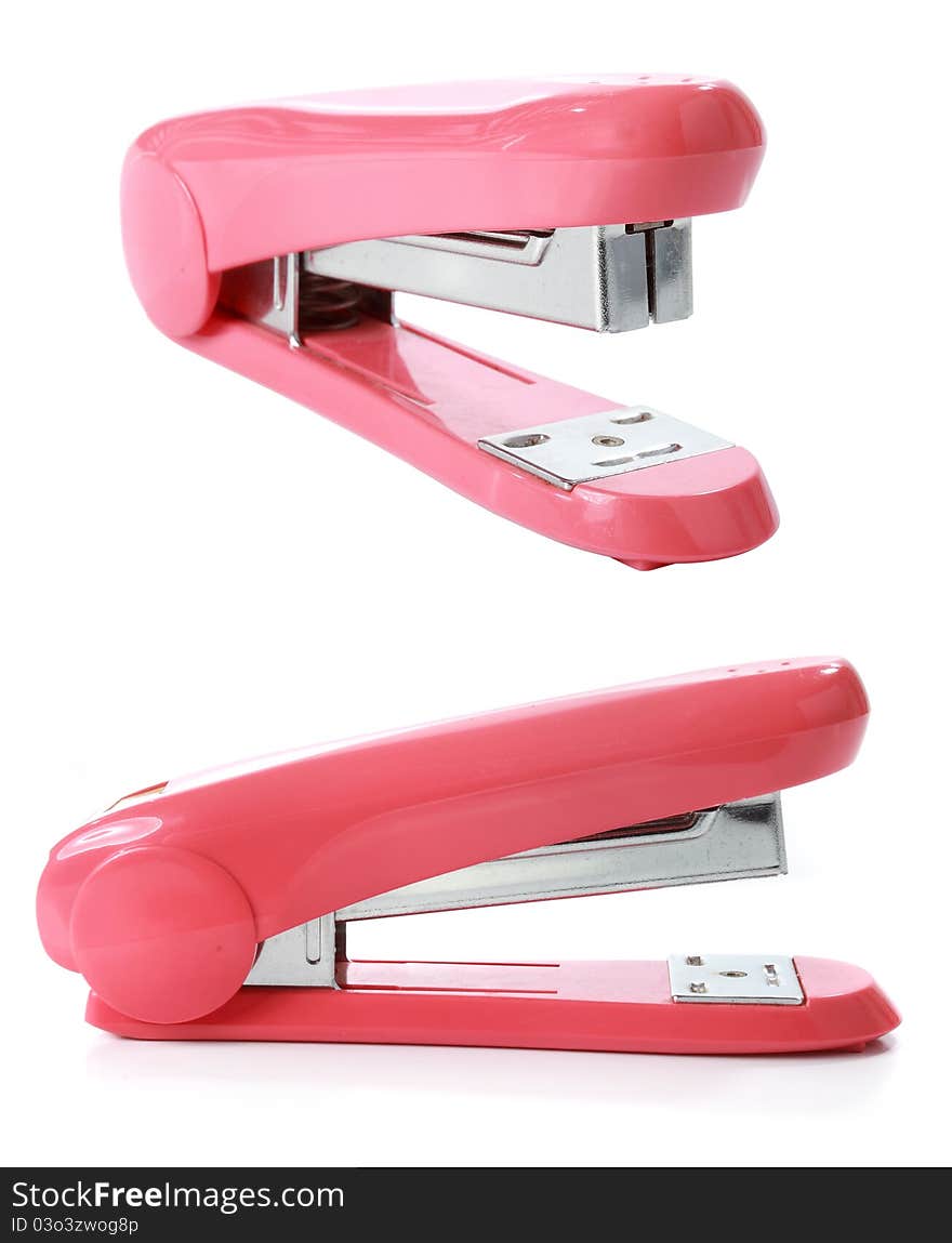 The pink stapler isolated over white