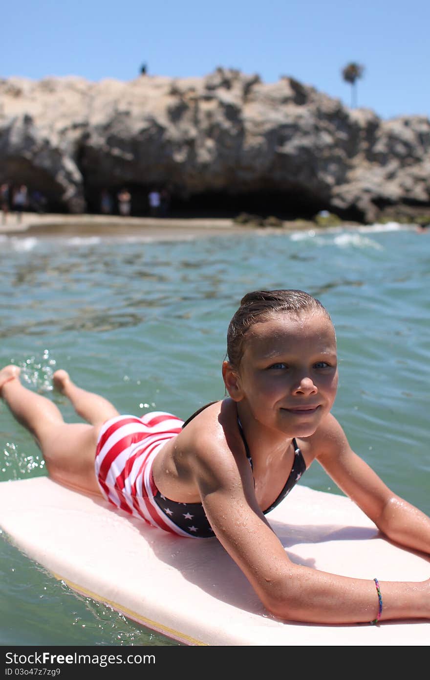 A young girl learning to boggie board. A young girl learning to boggie board