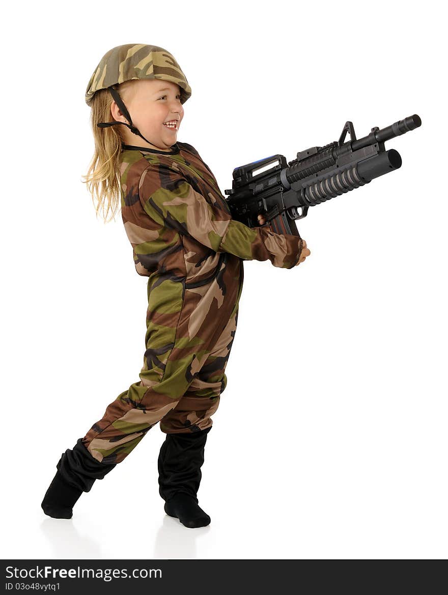 An adorable preschool soldier delightedly shooting her toy machine gun. Isolated. An adorable preschool soldier delightedly shooting her toy machine gun. Isolated.