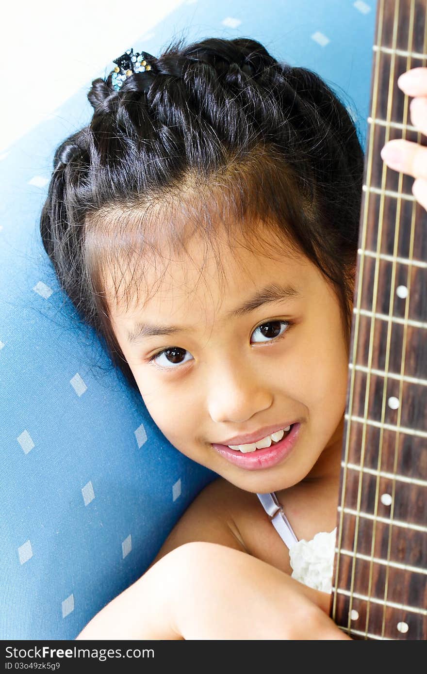 The girl on the guitar on the sofa. The girl on the guitar on the sofa