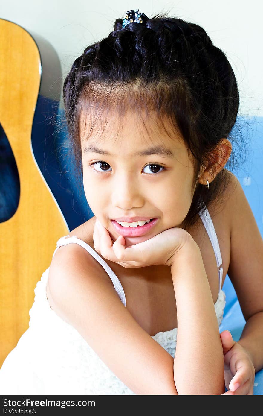 Girl sitting on the sofa and looked at the camera. Girl sitting on the sofa and looked at the camera