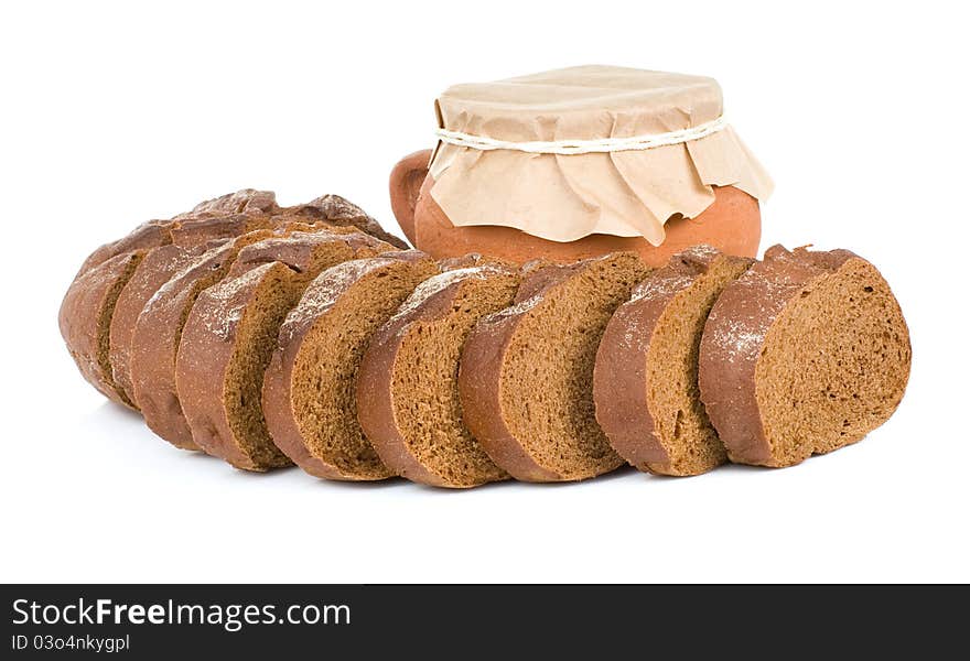 Loaf of bread and pot on white background