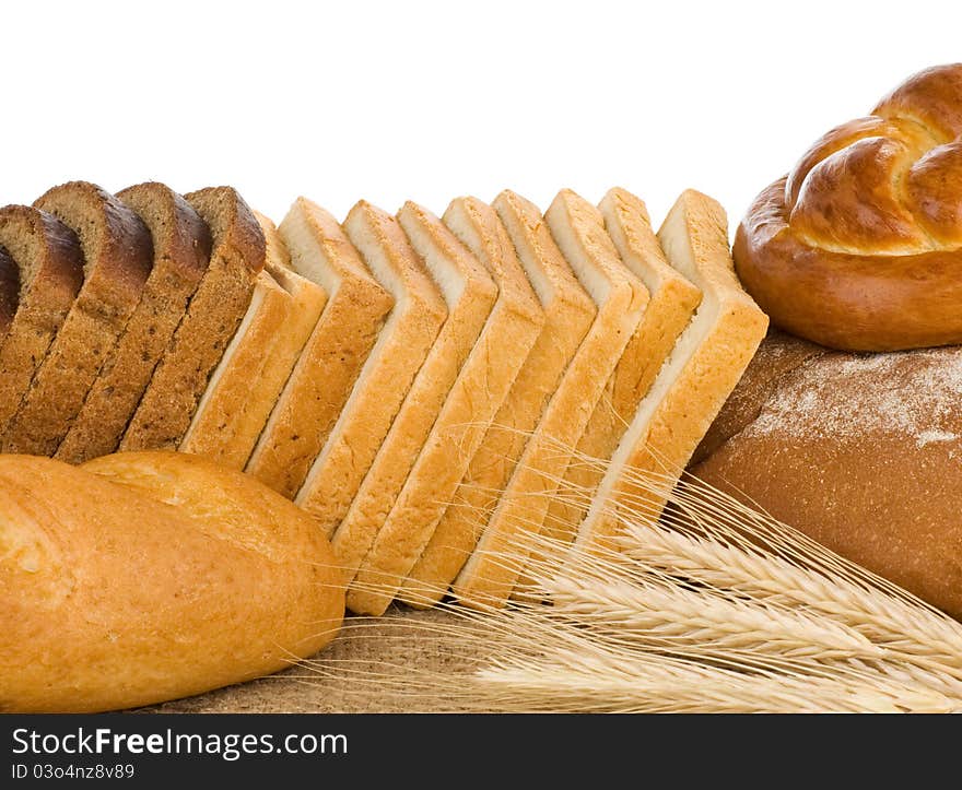 Bakery products and wheat with spike on white background