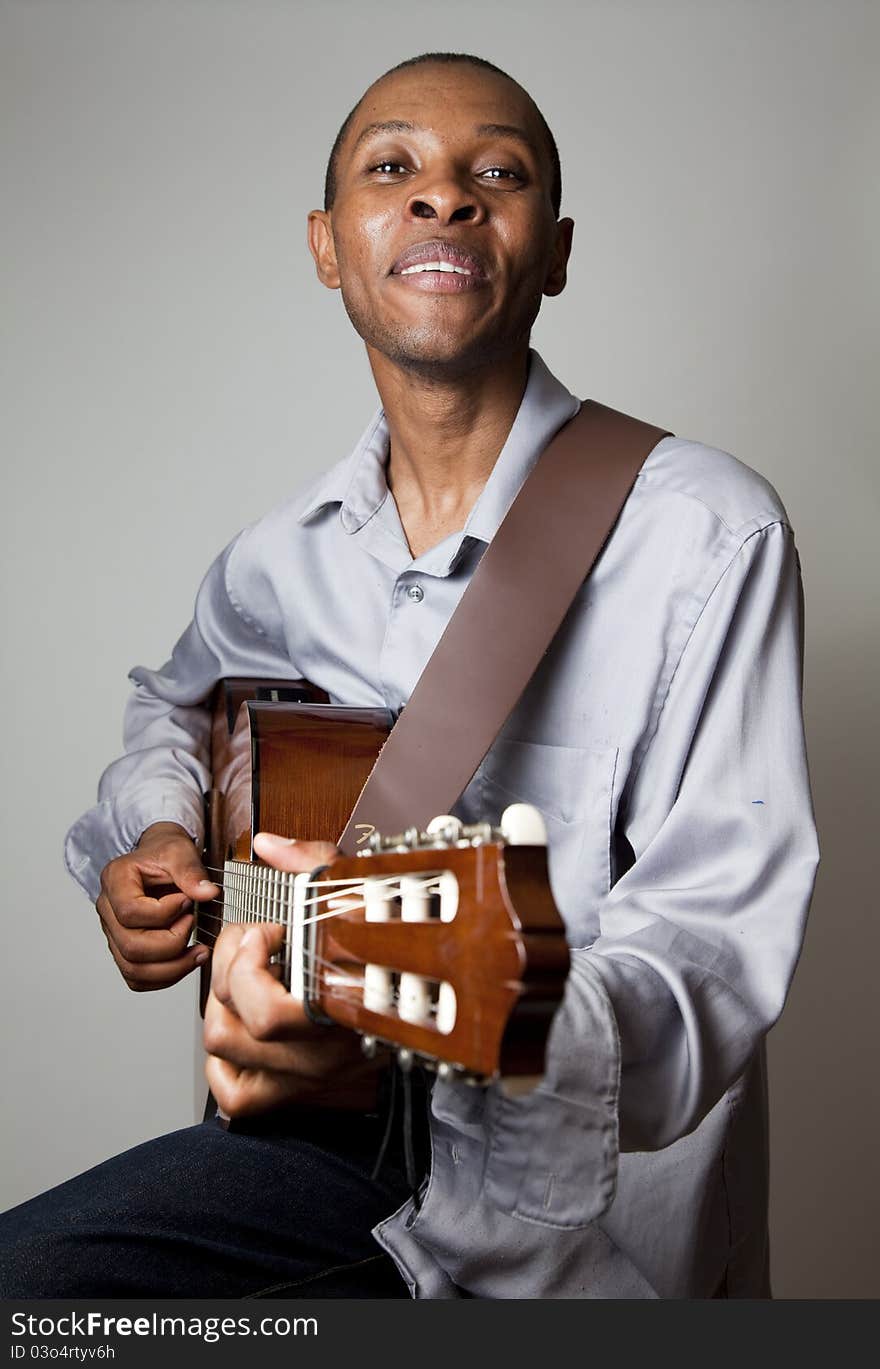 Portrait of a man playing the guitar.