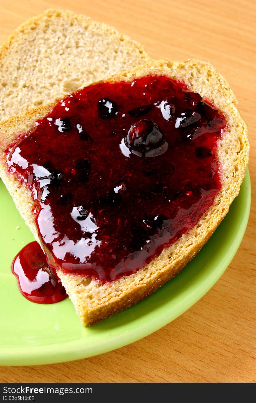 Bread and jam in a green plate. Bread and jam in a green plate