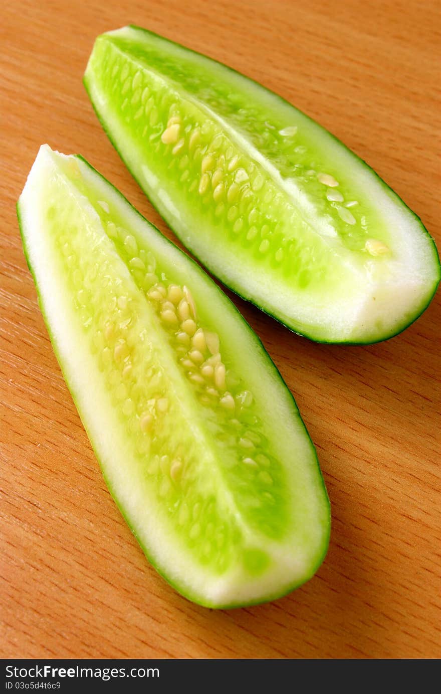 Two pieces of cucumber on the table. Two pieces of cucumber on the table