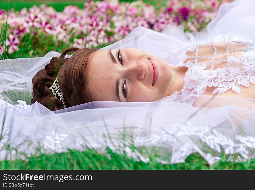 Portrait of a beautiful bride on the grass