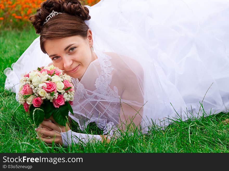 Portrait of a beautiful bride on the grass