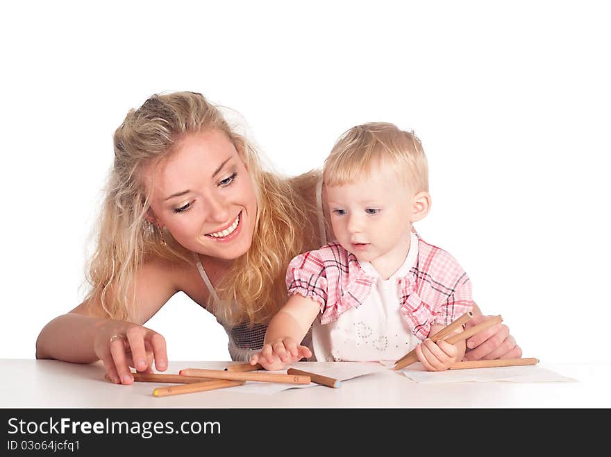 Mom and her daughter drawing at table. Mom and her daughter drawing at table