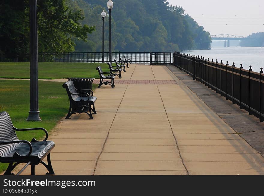 Chairs beside a lazy river with bridge in the background. Chairs beside a lazy river with bridge in the background