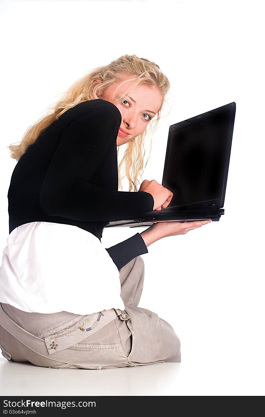 Cute blonde with a laptop at the table. Cute blonde with a laptop at the table