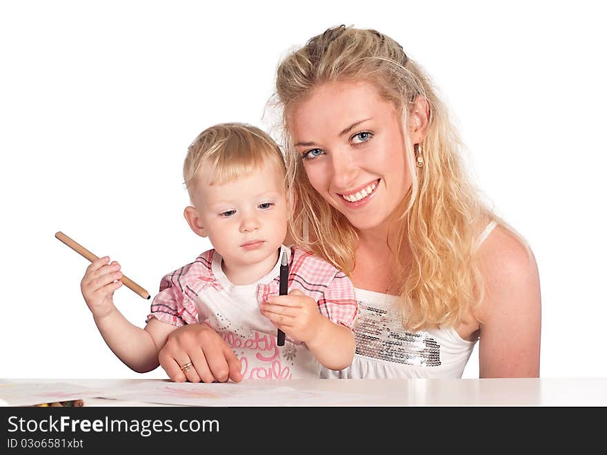 Mom and her daughter drawing at table. Mom and her daughter drawing at table