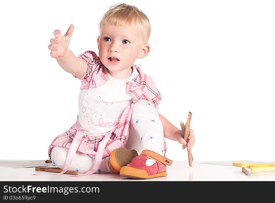 Little girl draws on the floor on white. Little girl draws on the floor on white