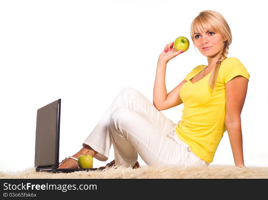 Cute girl with laptop on a carpet