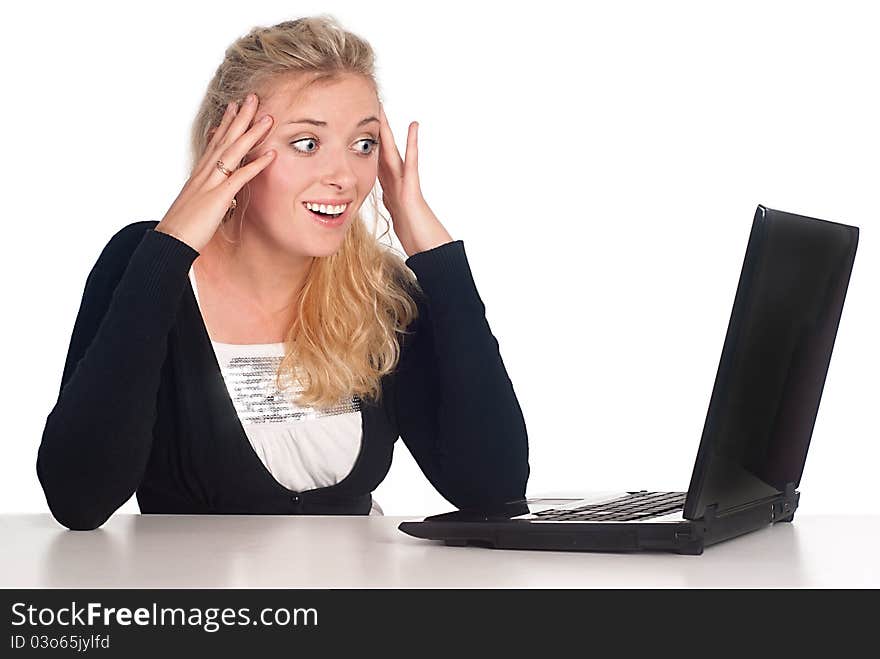 Cute blonde with a laptop at the table. Cute blonde with a laptop at the table