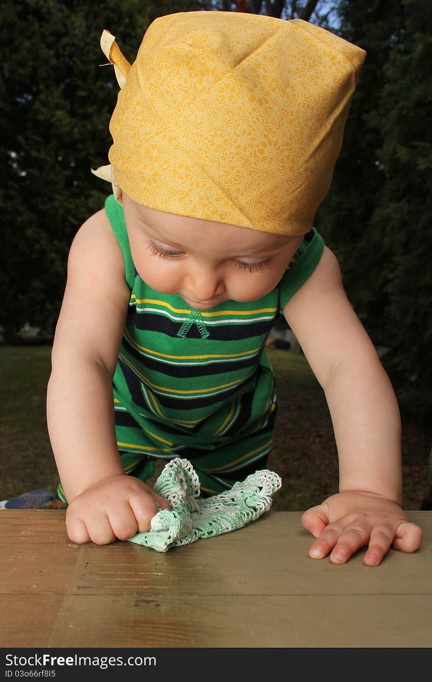 Cute baby boy outside in the garden wearing green outfit. Cute baby boy outside in the garden wearing green outfit