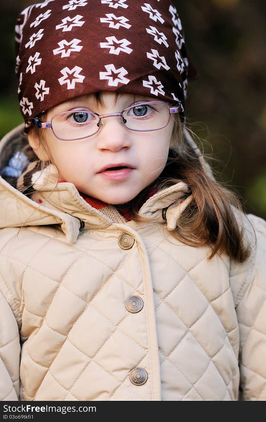 Portrait of adorable toddler girl wearing kerchief