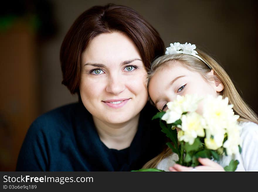 Portrait of lovely mother and child with flowers