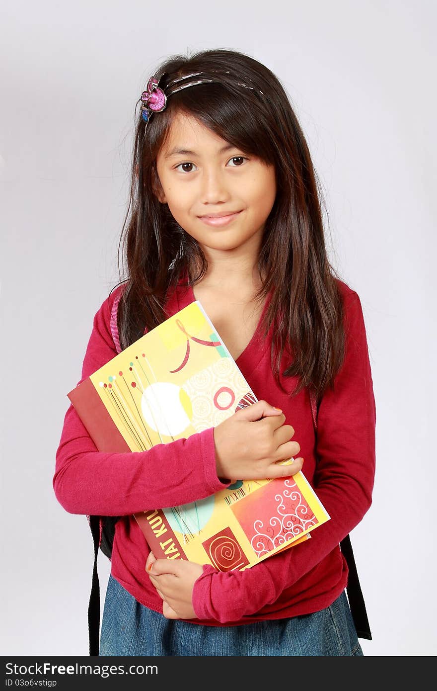 Portrait Of Girl Smiling With Backpack And Books