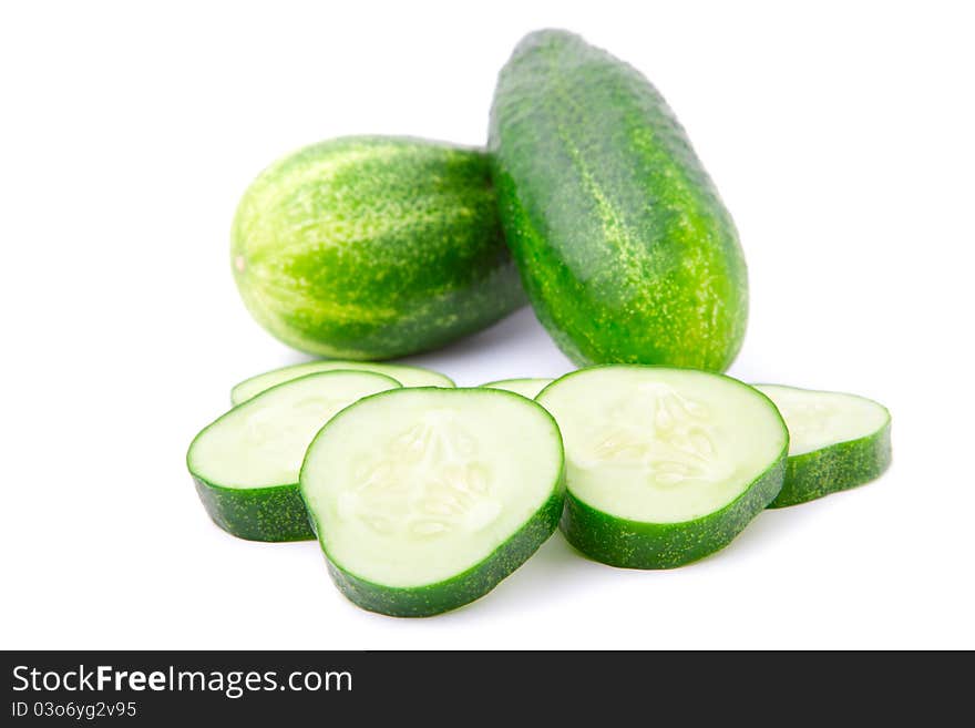 Cucumber and slices over white background.