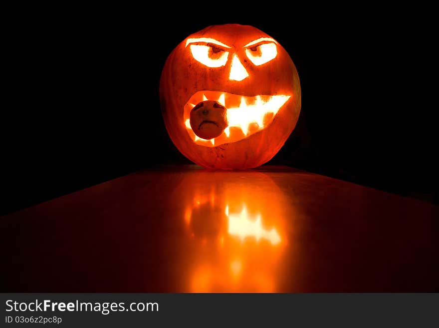 Halloween pumpkin light in the dark background, with reflections. Halloween pumpkin light in the dark background, with reflections