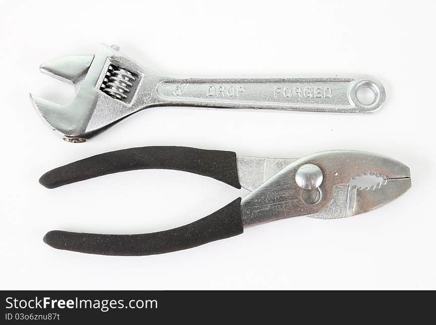 Silver and black pliers on white background