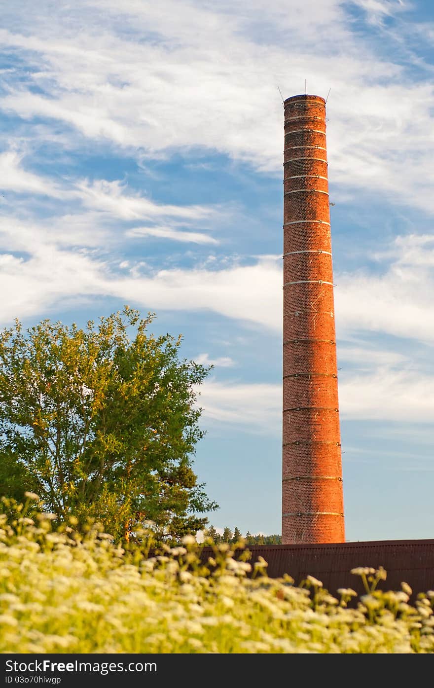 View of old smokestack during sunset time.