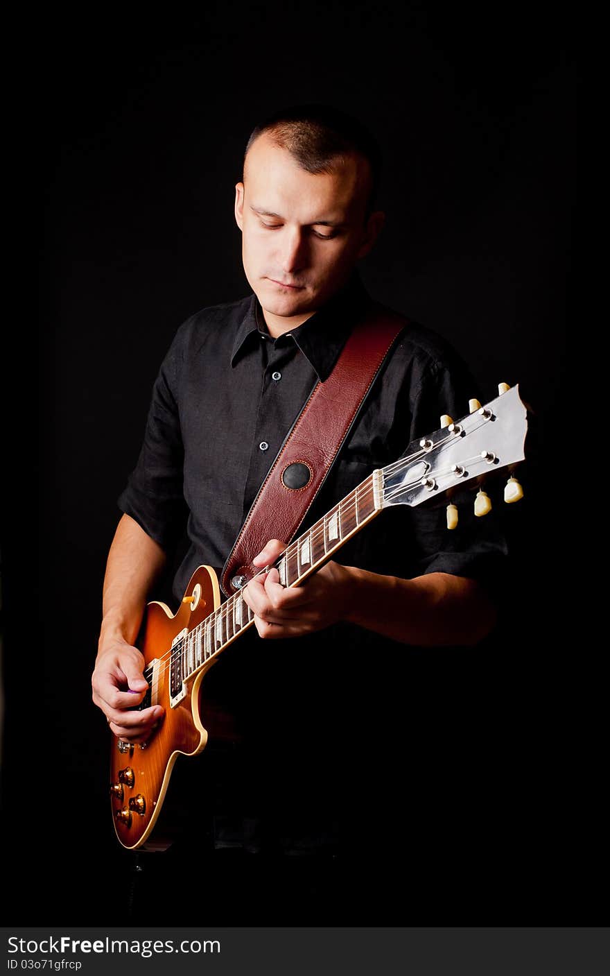 Handsome young man playing guitar