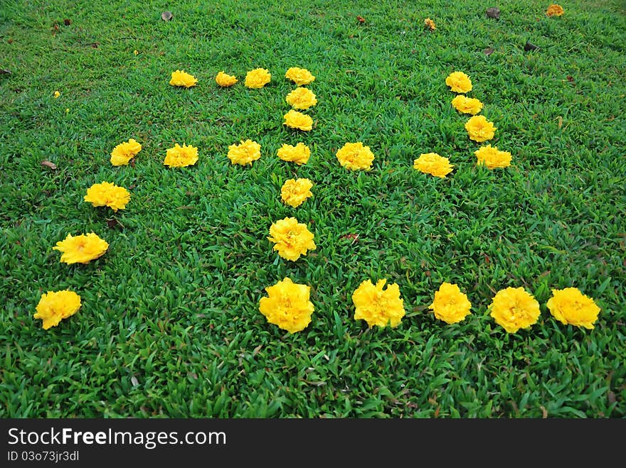 Fresh yellow flowers arranged to form the swastika symbol commonly used in religions such as Hinduism and Buddhism. Fresh yellow flowers arranged to form the swastika symbol commonly used in religions such as Hinduism and Buddhism.