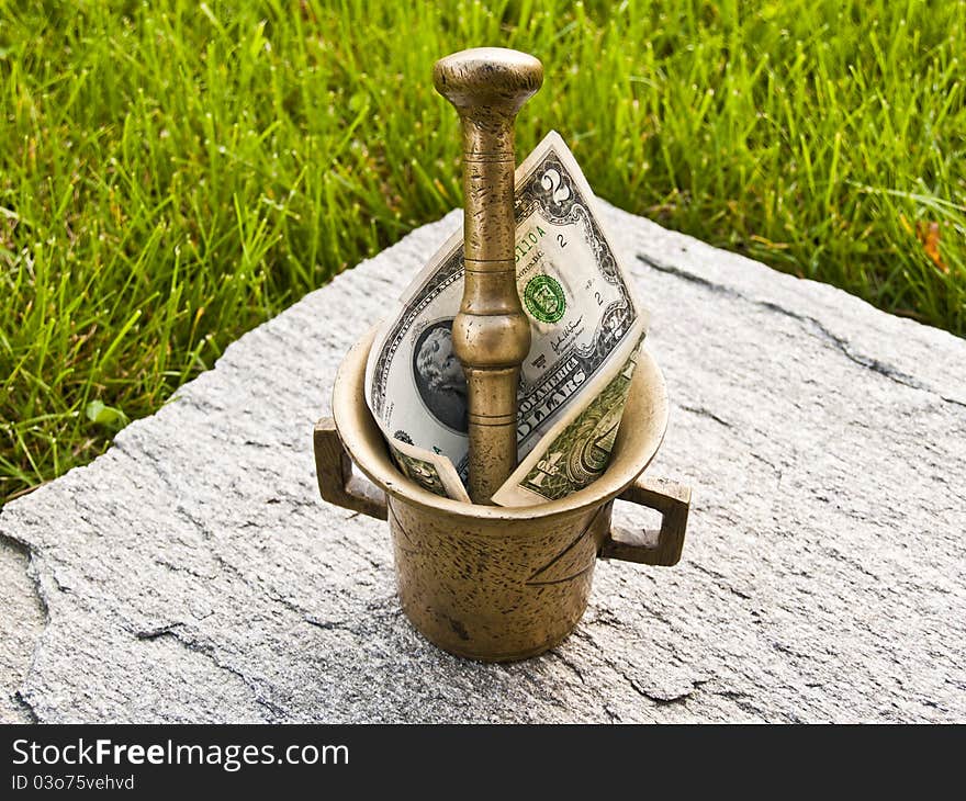 Mortar with dollar of green grass and stone