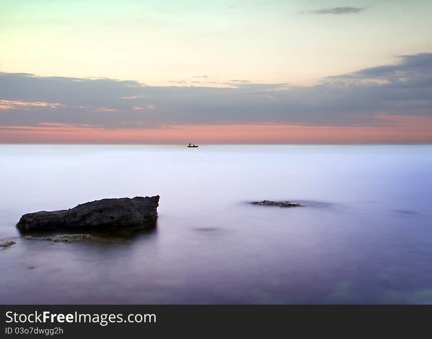 Sea and rock at the sunset. Seascape composition.