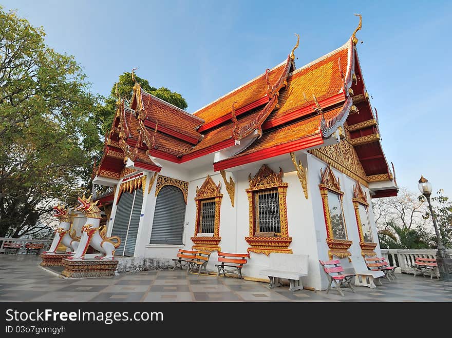 Small religious structure built with golden ornaments and intricately carved designs.