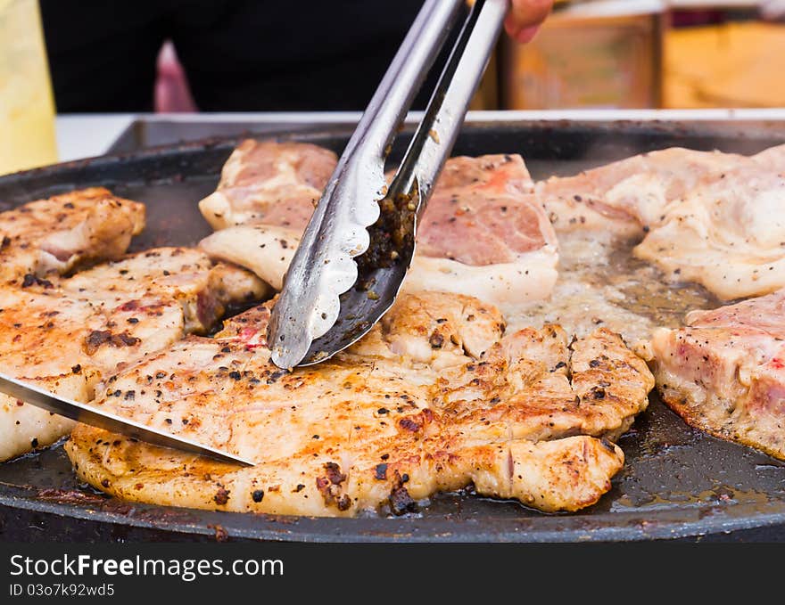 Grilled steaks are cut while cooking on the stove