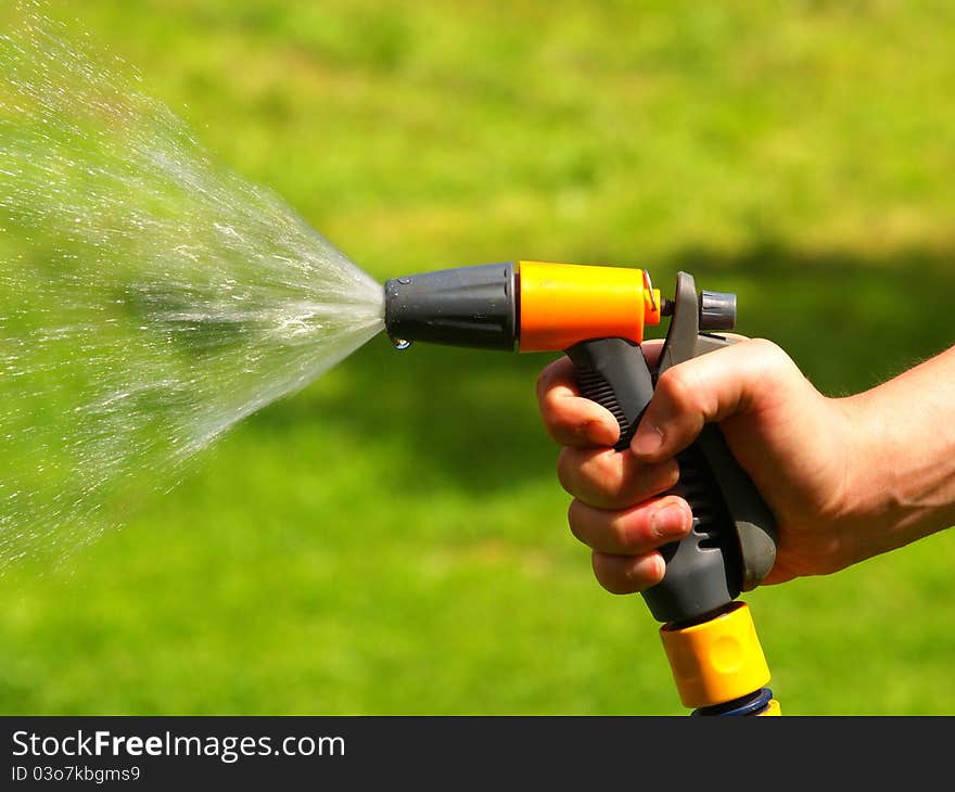 Garden hose. Green grass background. Garden hose. Green grass background.