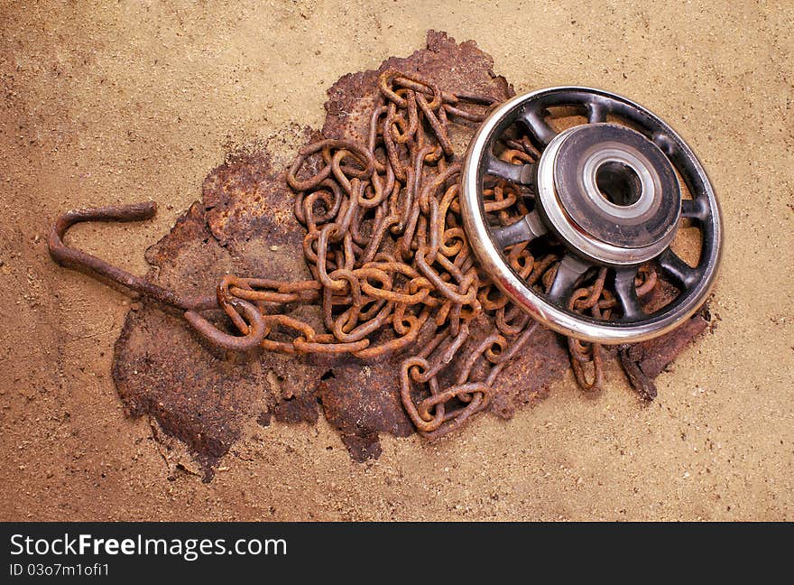 Rusty metal subjects on a sandy ground. Rusty metal subjects on a sandy ground.