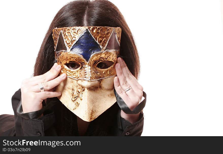 Photo studio with a model with Venetian mask covering his face and white studio background