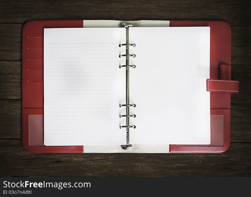 Blank note book on wood background