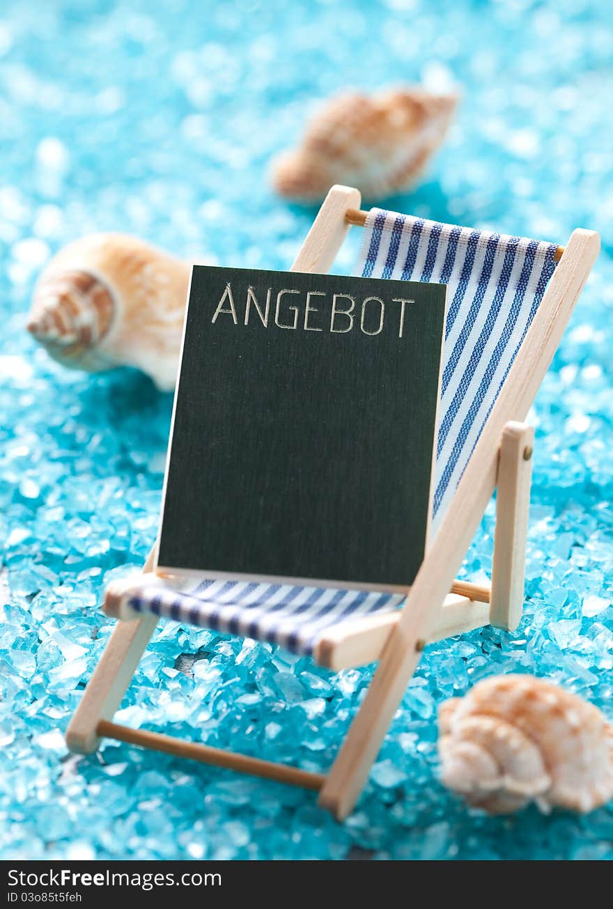 Holiday concept with deck chair and blackboard