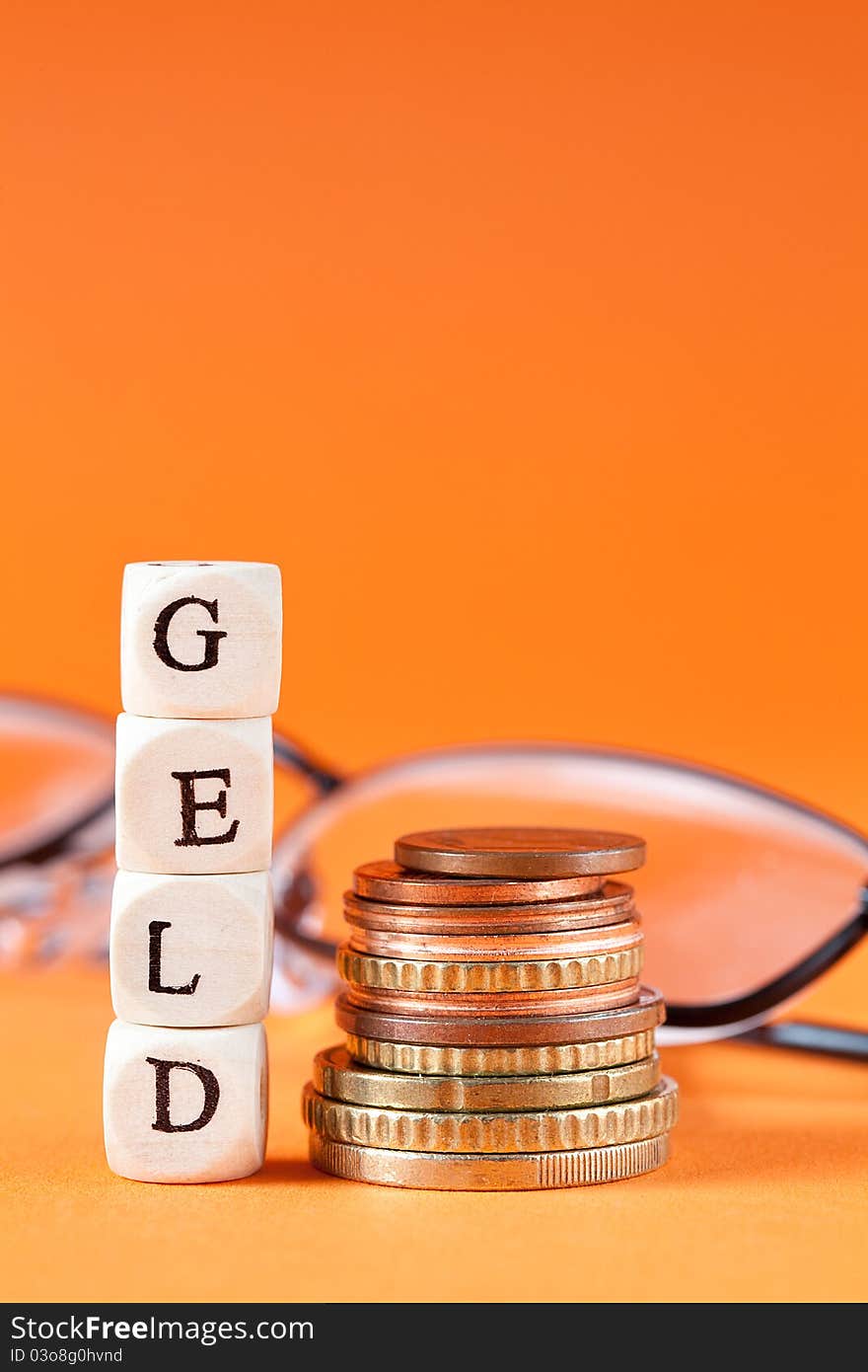 Euro coins and glasses with word geld in german. Euro coins and glasses with word geld in german