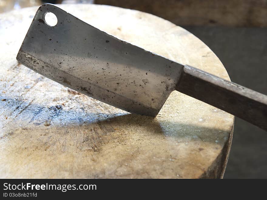 The dirty kitchen knife and chopping board.