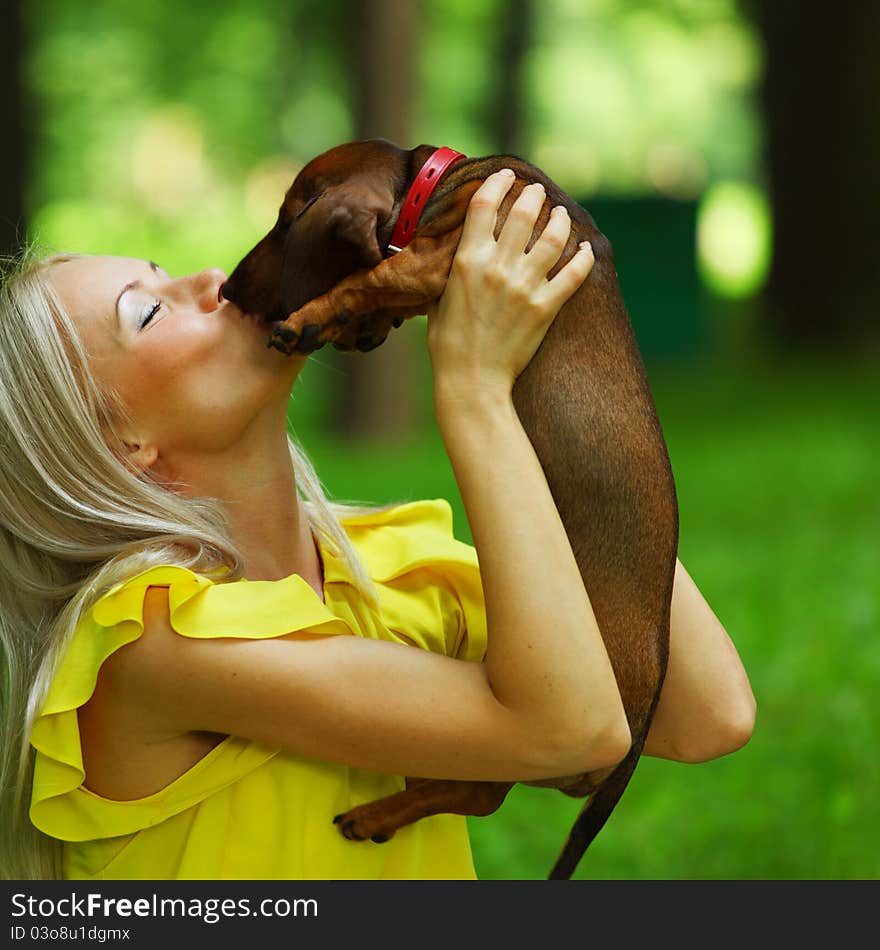 Woman dachshund in her arms on grass