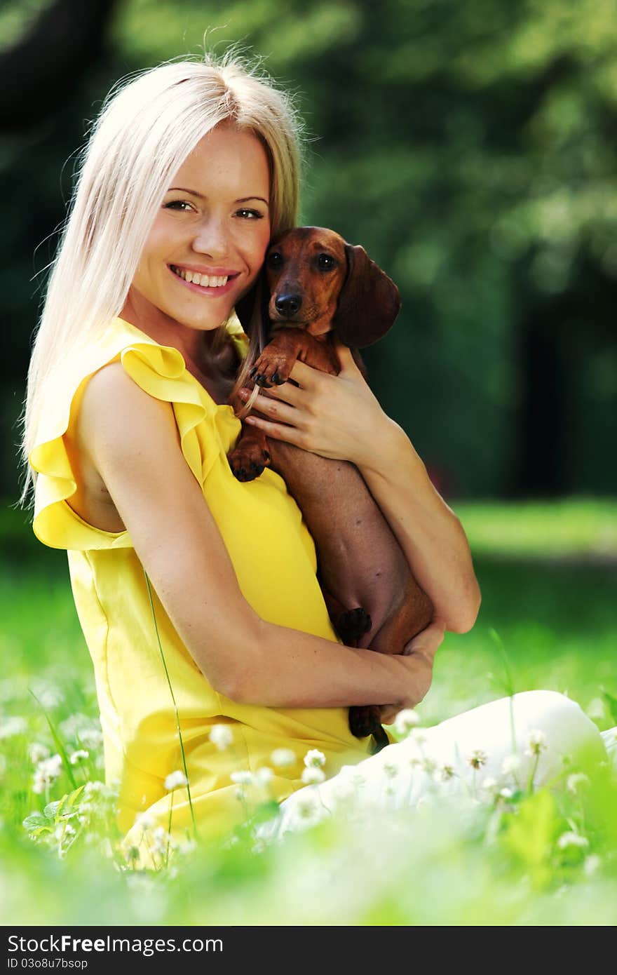 Woman dachshund in her arms on grass