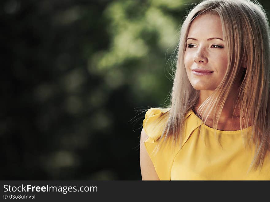 Happy woman posing against a background of trees. Happy woman posing against a background of trees