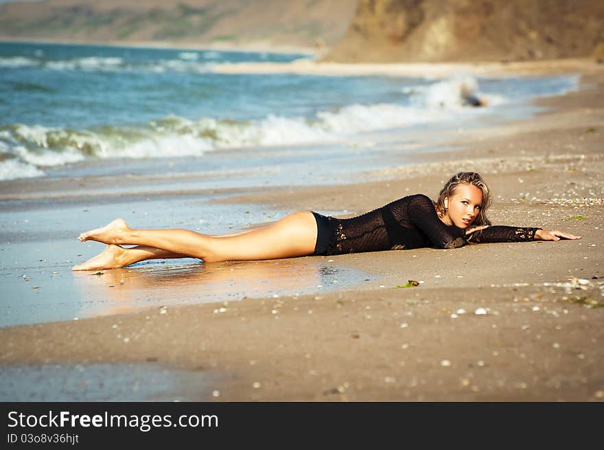 The lonely girl on an ocean coast