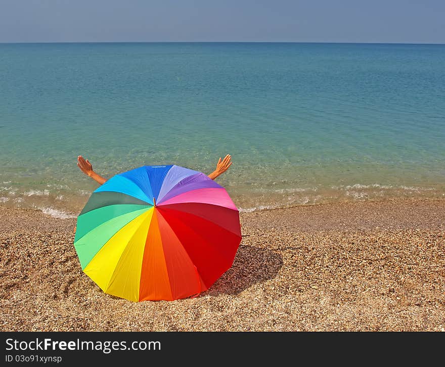 Rainbow beach umbrella and sea